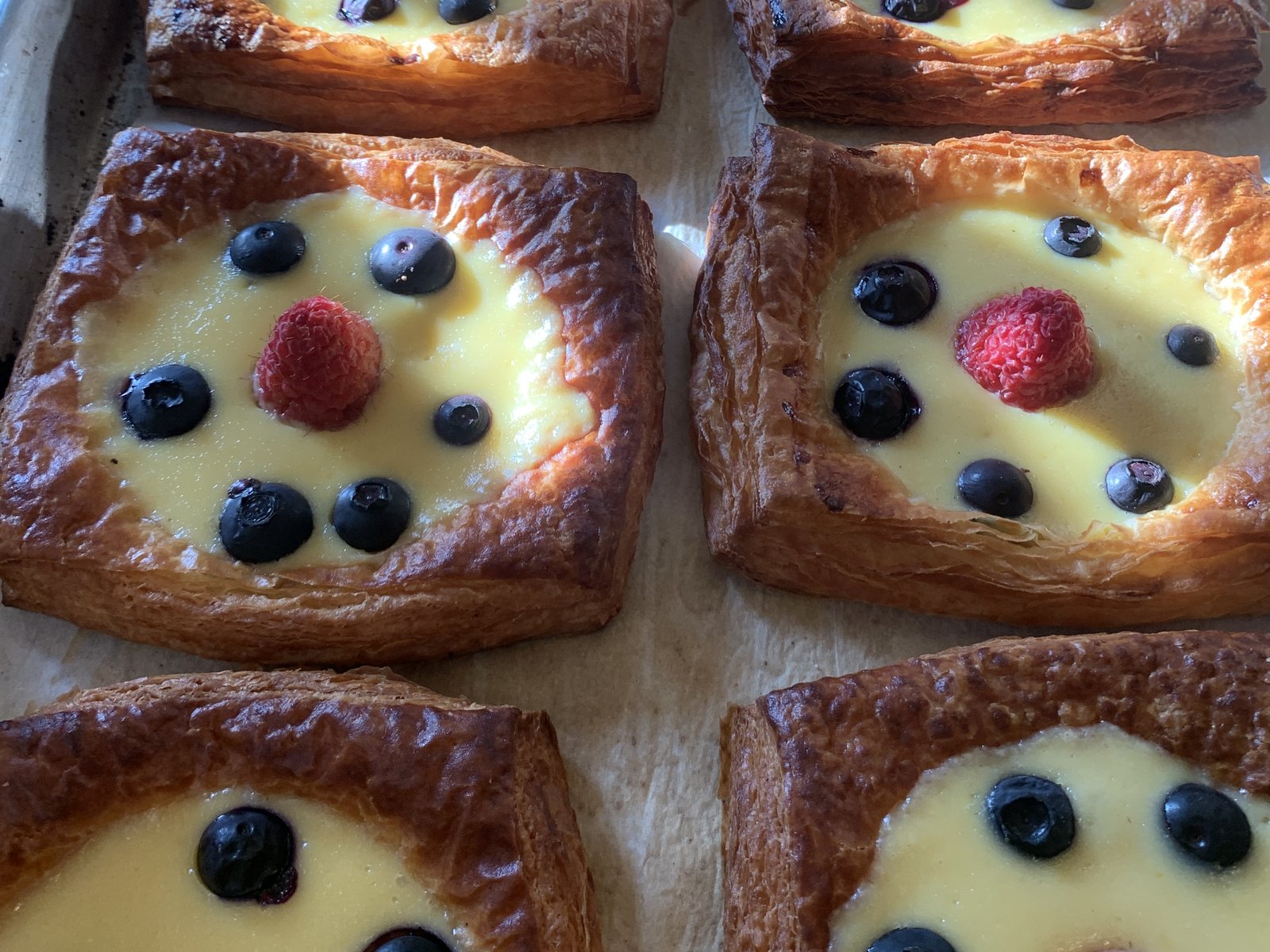 Danish pastries filled with vanilla custard and topped with berries